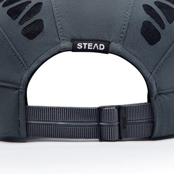 The back of the cap: strap, buckle and the woven STEAD label